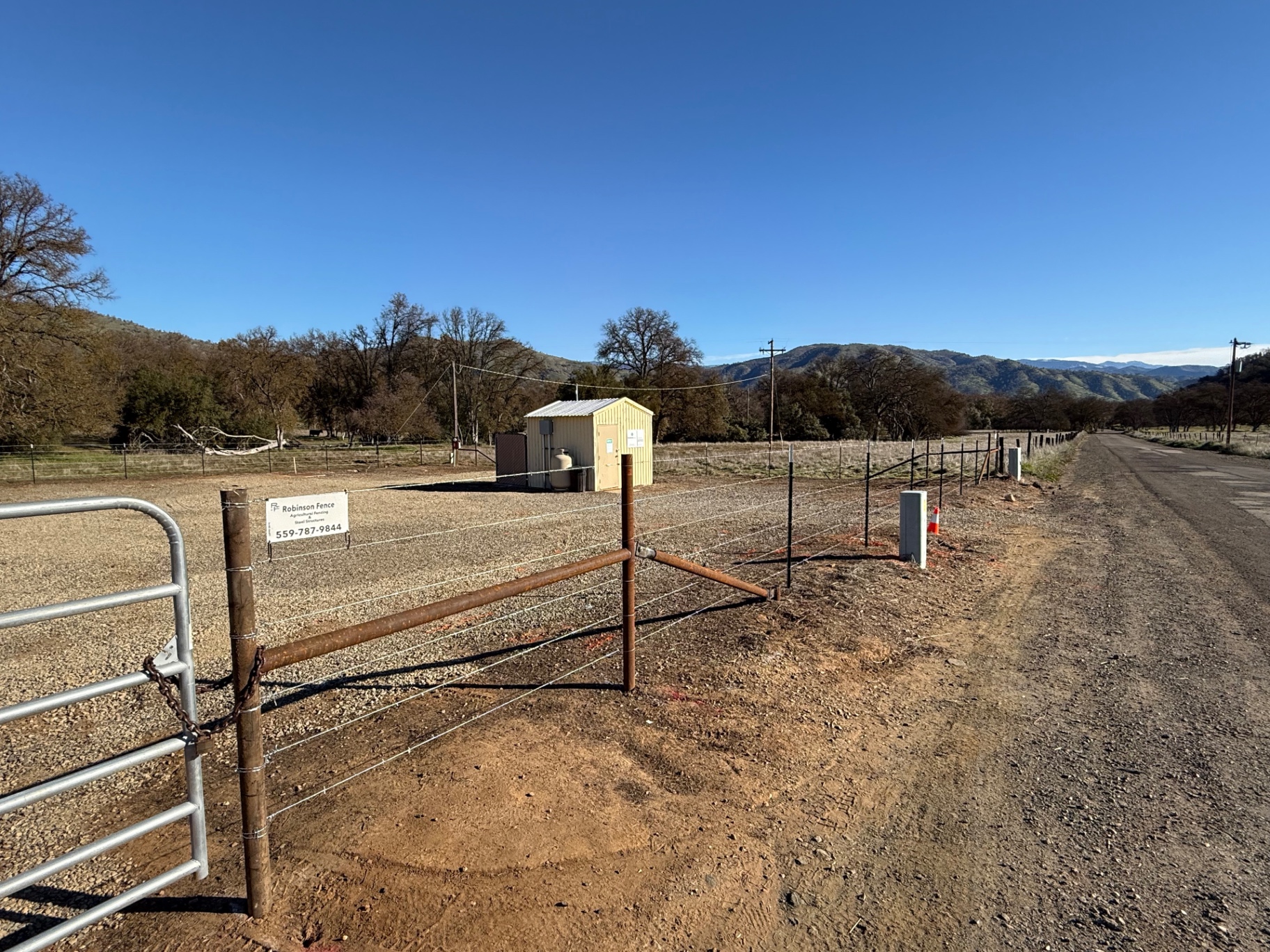 High-tensile wire ranch fence and pipe brace corner on a foothill property