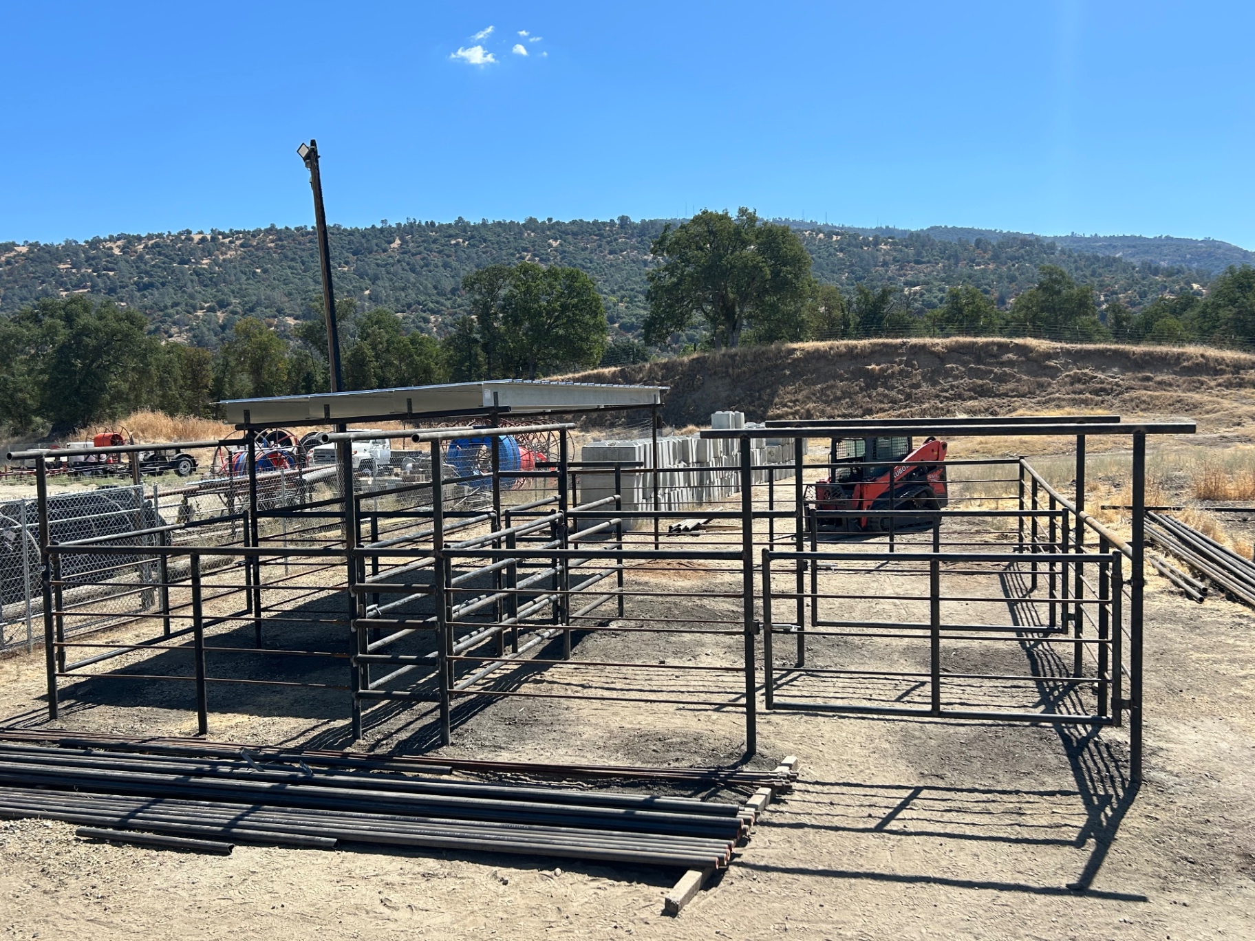 Continuous pipe panel corral system with sorting alley and swing gates